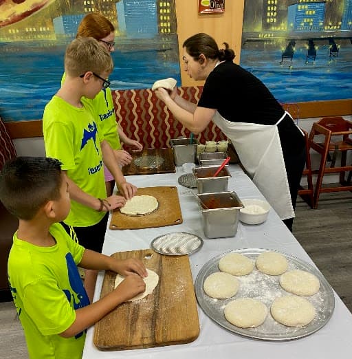 Kids making their own pizzas at NY Times Square Pizzeria