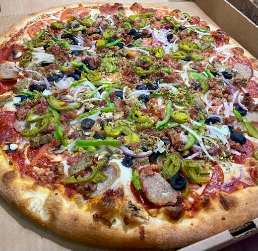 Supreme pizza with pepperoni, sausage, peppers and onions