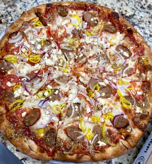 Pizza with sausage, banana peppers and onions