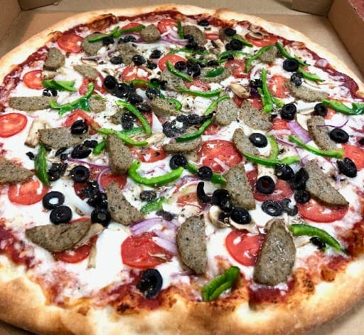 Pizza with sausage, peppers, olives and tomatoes