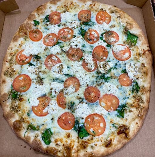 White pizza with tomato and spinach